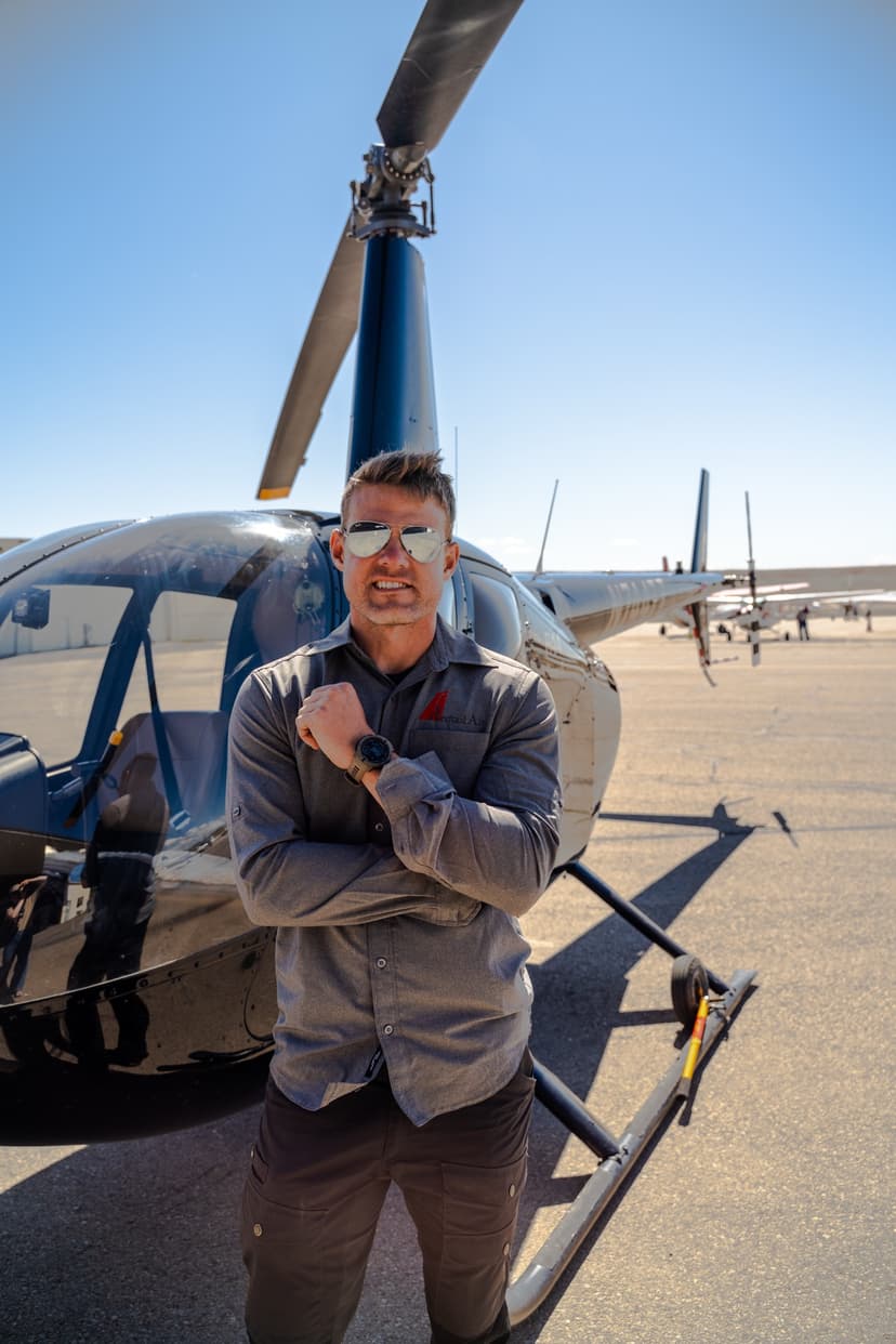 Helicopter pilot in front of aircraft at Moab airfield